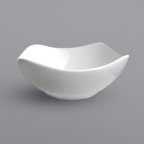 A close-up of an International Tableware white porcelain bowl with a flared rim.