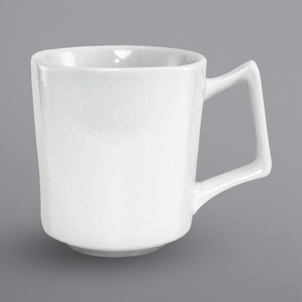 A close-up of a white International Tableware porcelain mug with a handle.