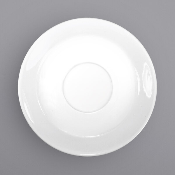 A white porcelain saucer with a circle in the middle.