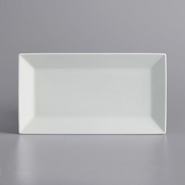 A white rectangular International Tableware porcelain platter on a white surface.