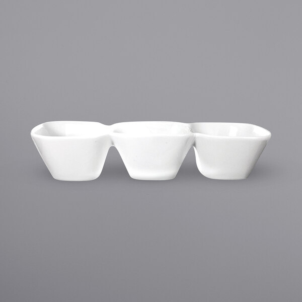 Three white International Tableware porcelain bowls with three square wells.