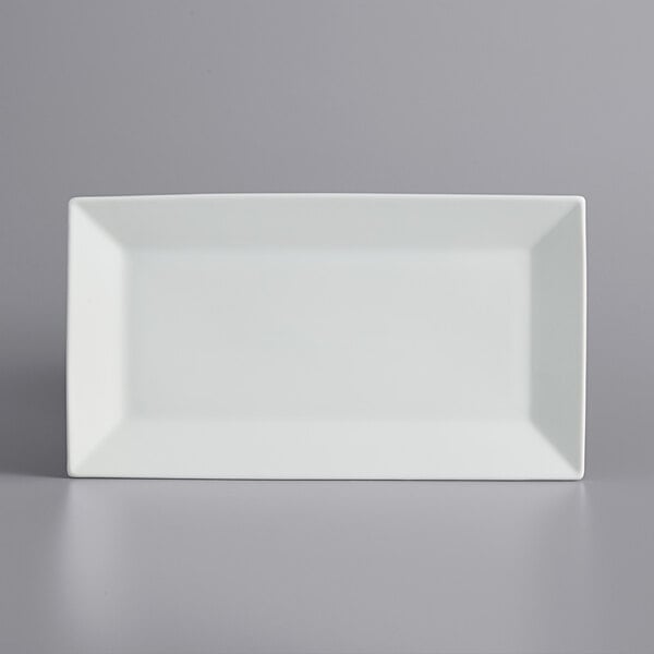 A white rectangular International Tableware porcelain platter with a wide rim.