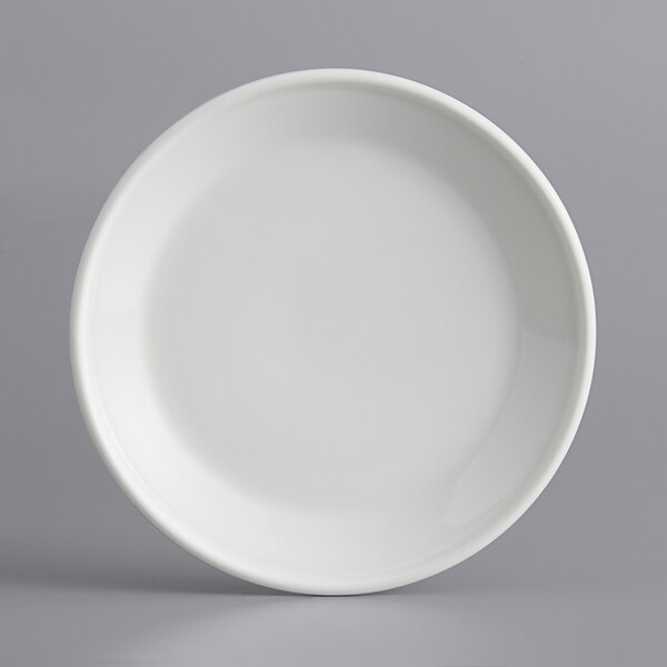 An International Tableware European white porcelain plate with a raised edge.