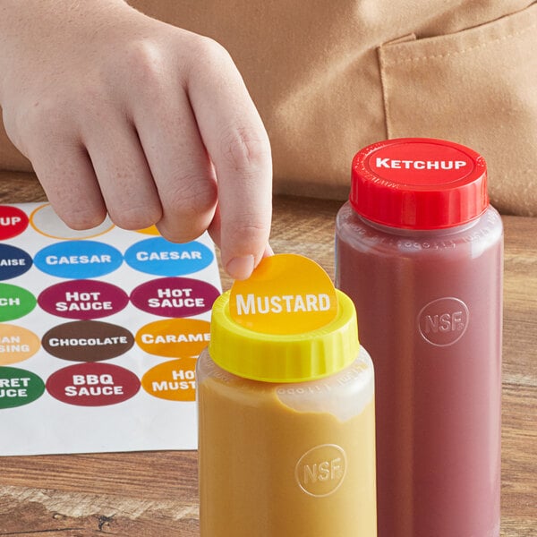 A hand using a FIFO Innovations Sauce Identification label to point at a bottle of mustard.