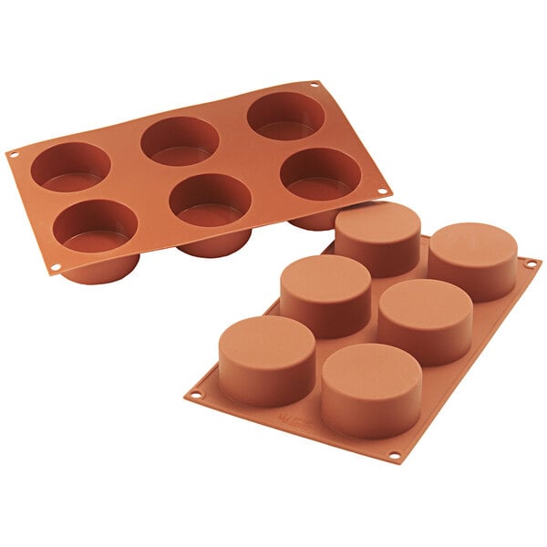 A Silikomart silicone baking mold with six cylindrical cavities.