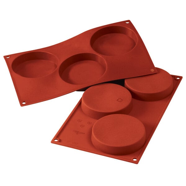 A red Silikomart silicone baking mold with four compartments.