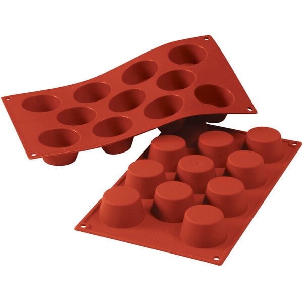 A red Silikomart silicone baking mold with 11 small cavities.