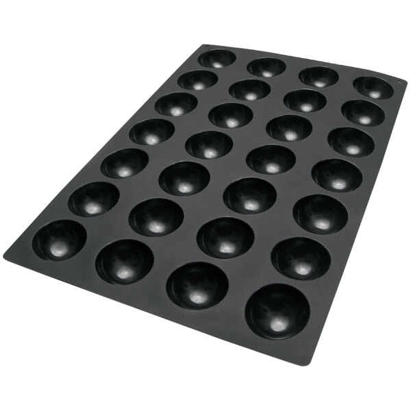 A black silicone baking mold with 28 semi-sphere cavities on a white background.