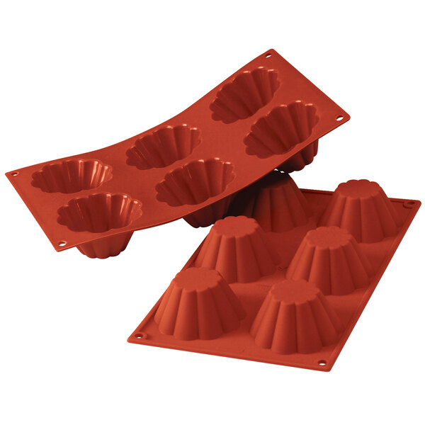 A close up of a red Silikomart silicone baking mold with 6 compartments.