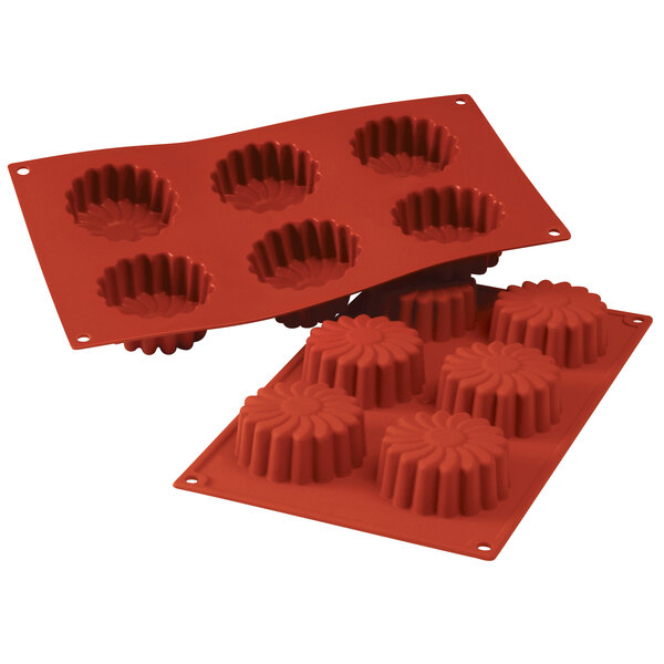 A red Silikomart silicone baking mold with 6 daisy-shaped cavities.