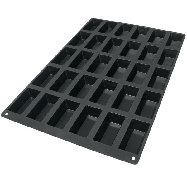 A black Silikomart silicone baking mold tray with 30 rectangular compartments.