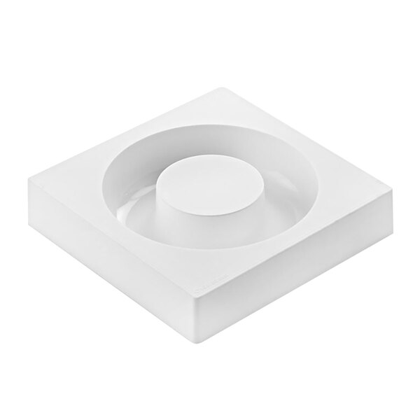 A white square silicone baking mold with a circular cavity in the center.
