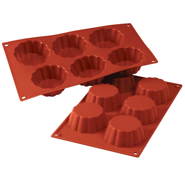 A close-up of a red Silikomart silicone mold with 6 briochette cavities.