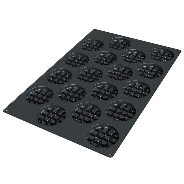 A black Silikomart silicone baking mold with round waffle cavities.
