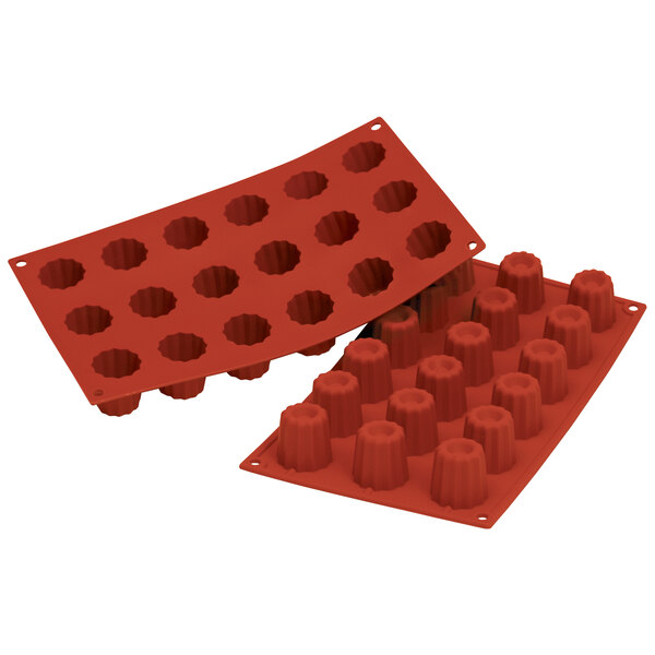 A red Silikomart silicone baking mold with 18 small square cavities.