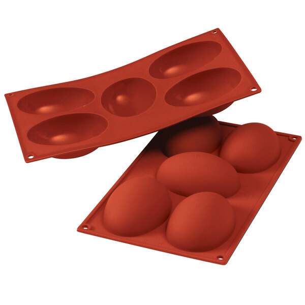 A red Silikomart silicone baking mold with 5 half egg cavities.