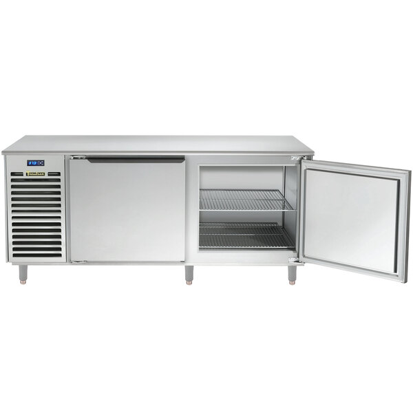 A Traulsen stainless steel undercounter refrigerator with an open door.