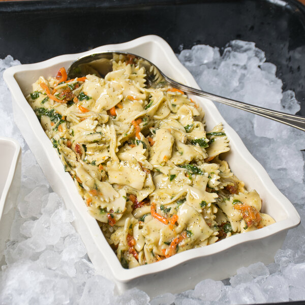 A GET Create-a-Bar deli crock filled with pasta and vegetables with a spoon in it.