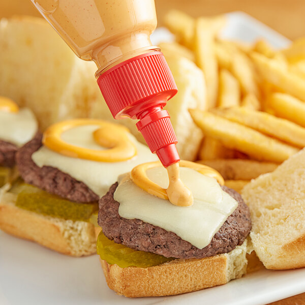 A close up of a Lee Kum Kee Sriracha Mayonnaise bottle on a table with a burger
