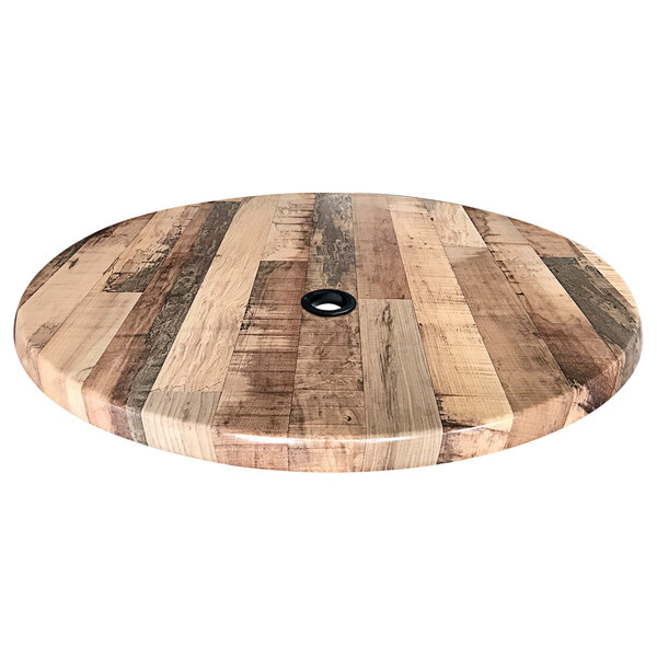 A wooden round table top with a hole in the center.