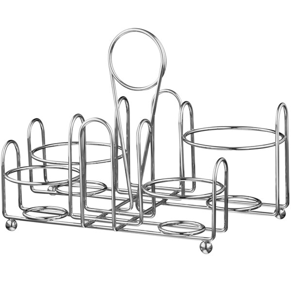 A silver metal Vollrath wire rack with four round condiment containers in it.