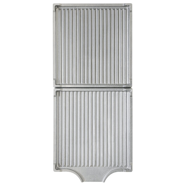 A close-up of a pair of silver metal grill plates with a grid pattern.