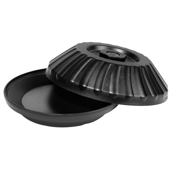A black round pan with a lid on it.