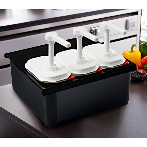 A black rectangular container with white airtight lids and three white pumps inside.