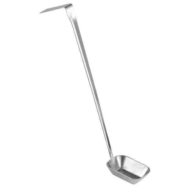 A silver metal rectangular ladle with a long handle.