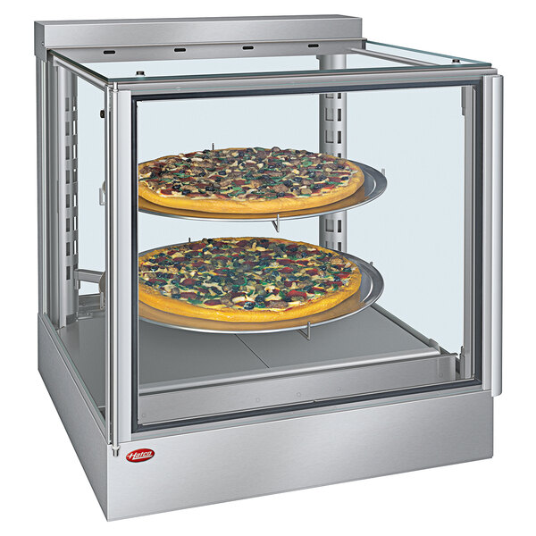 A Hatco stainless steel heated display case with pizzas inside.