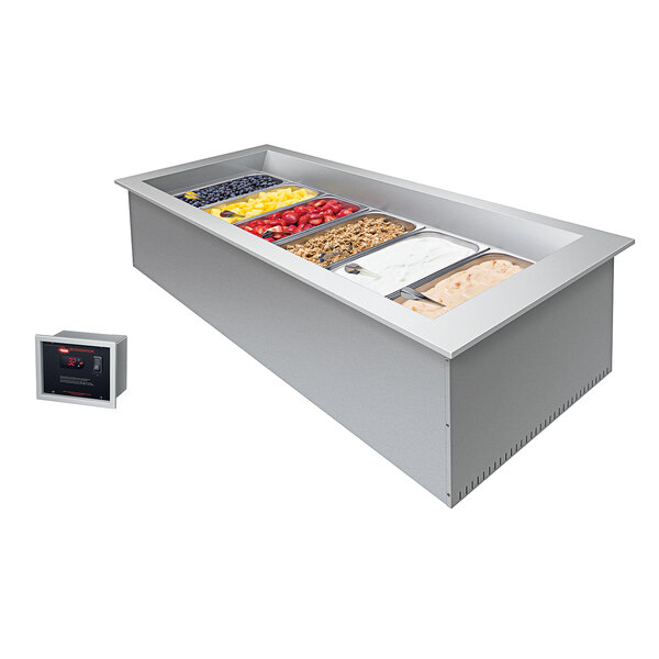 A Hatco drop-in refrigerated cold food well with three rectangular pans of food in it.