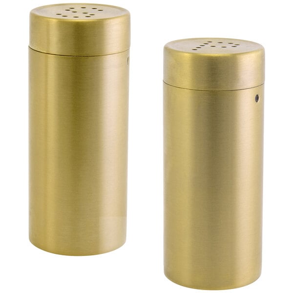 A pair of matte brass stainless steel salt and pepper shakers.