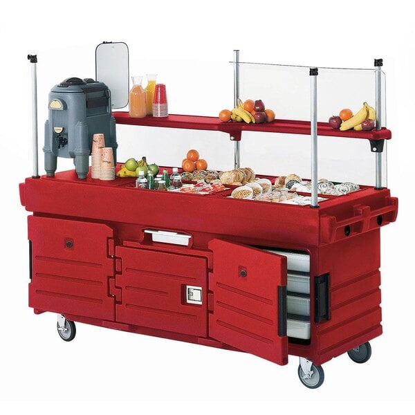 A red Cambro CamKiosk vending cart with food items on it.