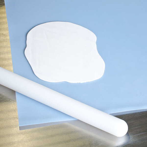 A white piece of paper with a white silicone mat with measurements.