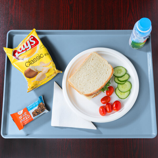 A plate of food and a drink on a Cambro robin egg blue dietary tray.