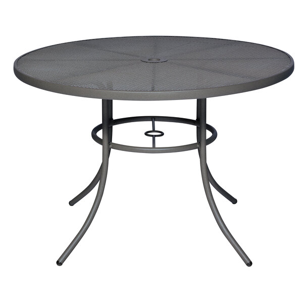 A Wabash Valley Sullivan round table with a black metal mesh top on a metal base.