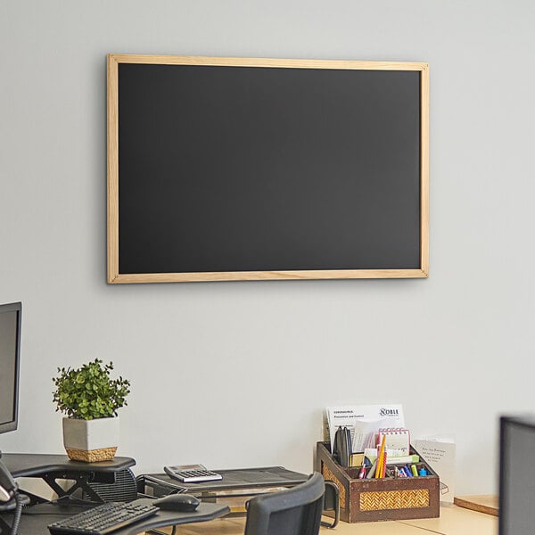 A Dynamic by 360 Office Furniture black wall-mount chalkboard with wood frame.