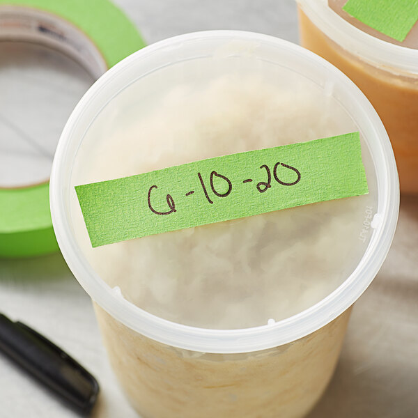 A container of food with a green tape and a Shurtape CP 631 label on it.