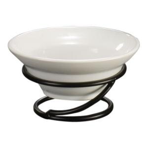 A white bowl on a wrought iron riser with a black wire holder.