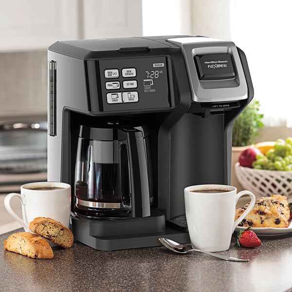 A Hamilton Beach FlexBrew coffee maker on a counter with two cups of coffee.