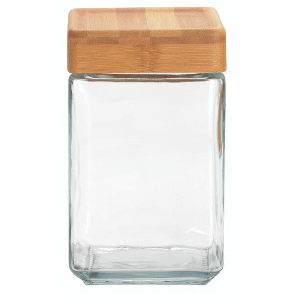 A clear square glass Anchor Hocking jar with a bamboo lid.