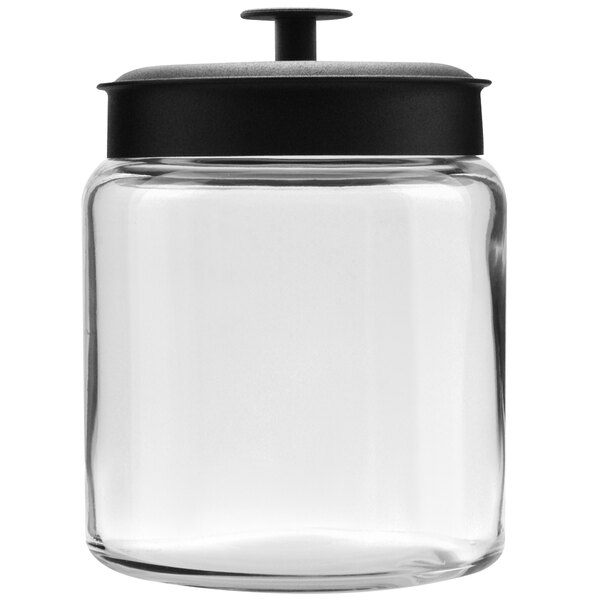 A clear glass Anchor Hocking mini jar with a black metal lid.
