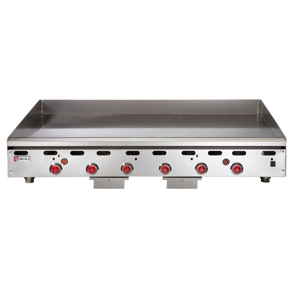A Wolf stainless steel gas griddle with thermostatic controls and red knobs.