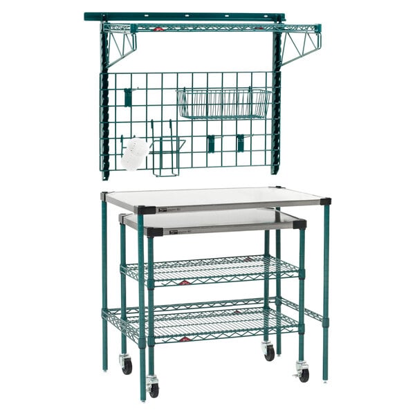 A green Metro Super Erecta prep station with a white SmartWall shelf and basket on top.