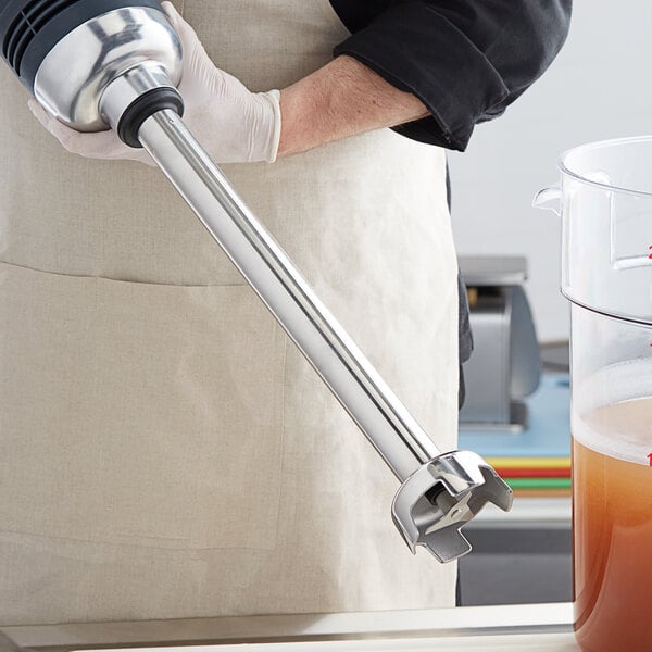 A person using an AvaMix heavy-duty blending shaft to make a drink with an immersion blender.