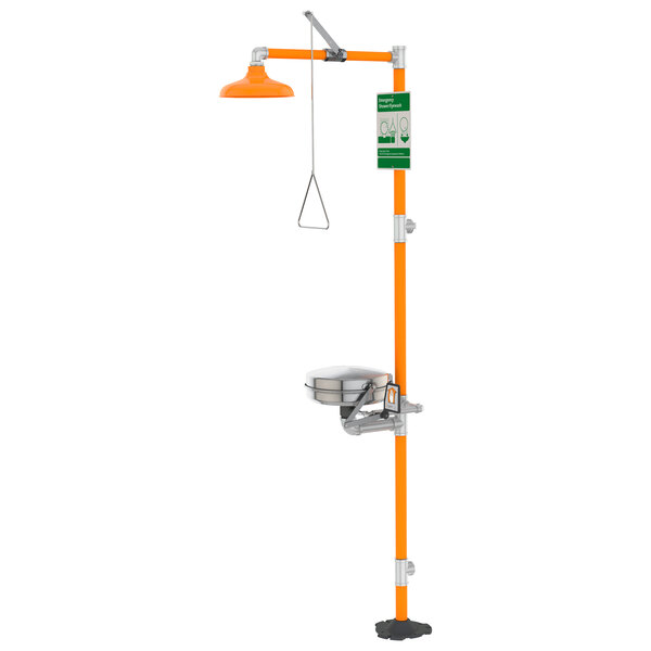 An orange and stainless steel eye/face wash station with a green and silver hose.