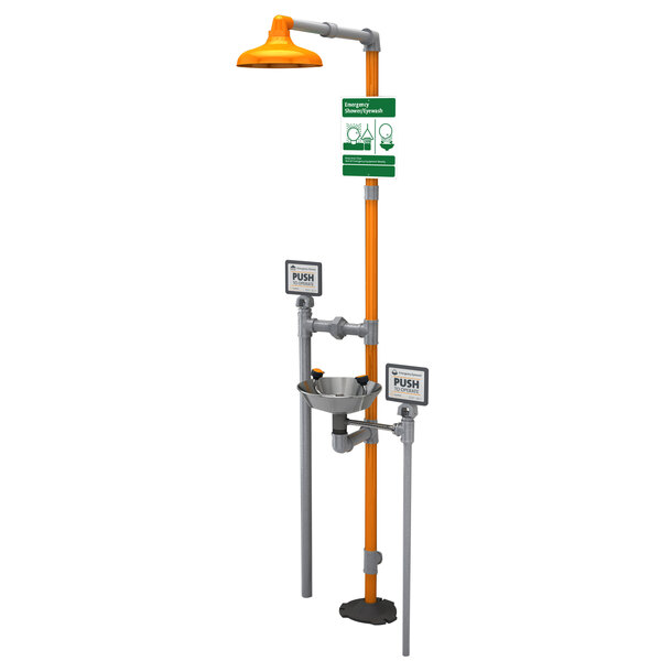 A Guardian Equipment freeze-resistant eye wash station with a green sign and orange handle.