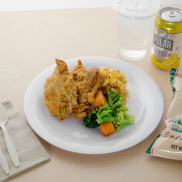 A Carlisle white melamine plate with food and a drink on a white table.