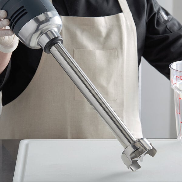 A person using the AvaMix heavy-duty blending shaft to make a drink.