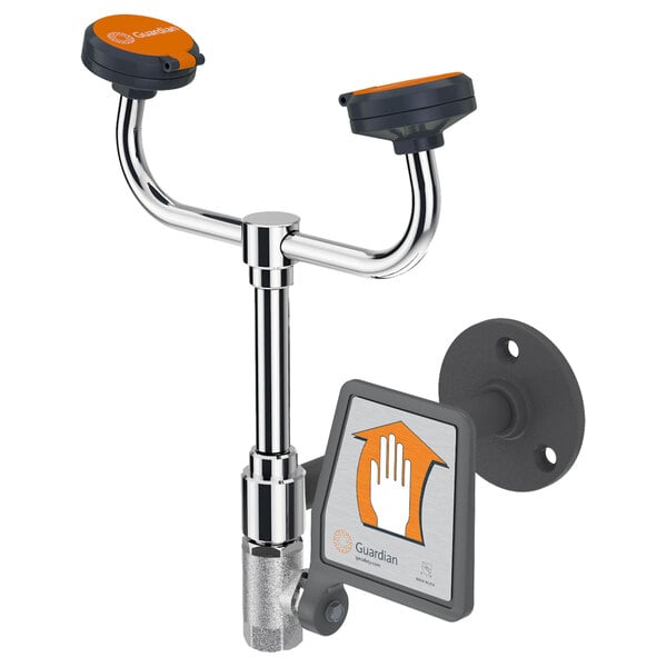 A metal wall-mounted eye and face wash station with orange handles.